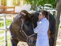 Young veterinarian examining horse with stethoscope looking to side Royalty Free Stock Photo