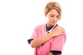 Female vet wearing pink scrub showing shoulder pain gesture Royalty Free Stock Photo