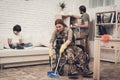 Female Veteran In A Wheelchair Is Cleaning House.