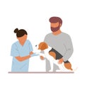 Female veterinary examining beagle with owner