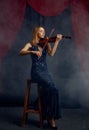 Female violonist with bow and violin, solo concert