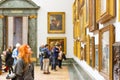 A female visitor admiring paintings displayed at Tate Britain