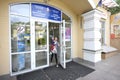 Female visitor with a baby on hands going out the hospital front doors