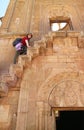 Female Visitor Climbing the Steep and Narrow Steps Projecting from the Facade of Surb Astvatsatsin Church