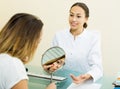 Female visitor consulting smiling doctor in medicine center Royalty Free Stock Photo