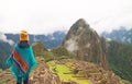 Female visitor impressed by spectacular ancient Inca ruins of Machu Picchu citadel, Cusco, Peru Royalty Free Stock Photo