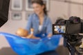 Female influencer filming video about newborn baby care