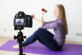 Female vlogger recording sports related broadcast at home Royalty Free Stock Photo