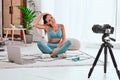 Female vlogger recording sports related broadcast at home Royalty Free Stock Photo