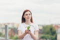Female volunteer holds in her hands a seedling of a flower tree Royalty Free Stock Photo