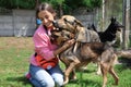 Female volunteer with homeless dogs at animal shelter
