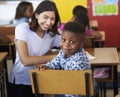 Female Volunteer teacher and elementary school boy smiling to camera Royalty Free Stock Photo