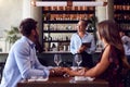 Female Waitress With Digital Tablet Taking Order From Romantic Couple Sitting At Restaurant Table Royalty Free Stock Photo