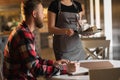 female waitress giving order to man, talk to client cafe restaurant visitor, friendly professional woman server wearing