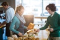 Female waitress packing sandwich in paper bag Royalty Free Stock Photo