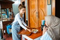 female waitress serving a bowl of chicken noodles to customers