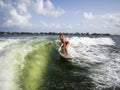 Female wake surfer riding wave in Miami intracoastal Royalty Free Stock Photo