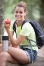 female walker having rest and eating apple