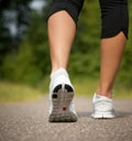 Female walking on path in running shoes Royalty Free Stock Photo