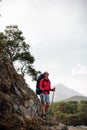 Female wanderer poses on top of the rock