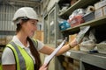 Female warehouse worker Counting items in an industrial warehouse