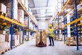 Female warehouse worker loading or unloading boxes. Royalty Free Stock Photo