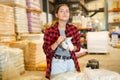 Female warehouse worker using smartphone to check quantity of goods Royalty Free Stock Photo