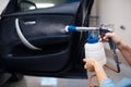 Female washer cleans automobile interior, car wash Royalty Free Stock Photo