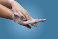 Female washing hands with soap and water with interlaced fingers