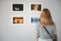 female watch at photo frame to leaning against at exhibit museum Royalty Free Stock Photo