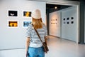 female watch at photo frame to leaning against at exhibit museum Royalty Free Stock Photo