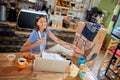 Female watching content on her laptop, laughing , with her legs on the table. casual, relaxed, break, pause concept