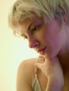 Close-up of pensive blondy looking down thinking Royalty Free Stock Photo