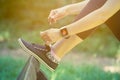 Female wearing smart watch and tying shoelaces in the park Royalty Free Stock Photo