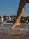 The female bare feet covered by drops of water, beach of recrei center in the morning, Croatia Royalty Free Stock Photo