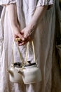 Female holding two white handmade ceramic teapots Royalty Free Stock Photo