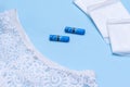 Womens white panties tampons, pads on a blue background