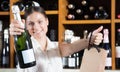 Female will offer wine inside the store Royalty Free Stock Photo