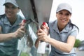 female window cleaner working outdoor with spray Royalty Free Stock Photo