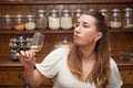 A female wine tester sampling a glass of white wine