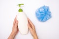 Female woman hands holding shower accessories, shower gel, body wash and a blue sponge, white background, top view Royalty Free Stock Photo