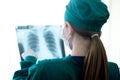 Female women medical doctor looking at x-rays in a hospital .checking chest x ray film at ward Royalty Free Stock Photo