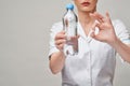 female woman nutritionist or dietician doctor healthy lifestyle concept - holding bottle of water