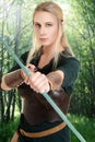 Female wood elf using bow and arrow Royalty Free Stock Photo