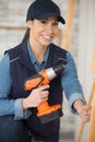 female woodworker holding rechargeable screwdriver