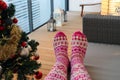 Female with Wool Socks Enjoying Christmas Holiday Season on a Balcony Royalty Free Stock Photo