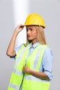 Female worker blonde hair lost her fingers from injured accident in industrial job. Woman engineer wear yellow hard hat show her