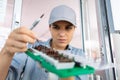 female worker choosing attachment for precision tool Royalty Free Stock Photo