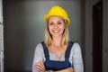Young woman worker with a yellow helmet on the construction site. Royalty Free Stock Photo