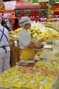 Female worker cut fruits